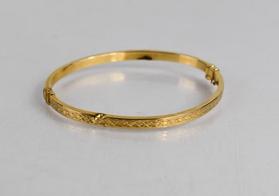 Lot 365 - A 9ct gold bangle, with spring hinge and...