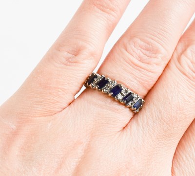 Lot 422 - An 18ct white gold, diamond and sapphire ring,...