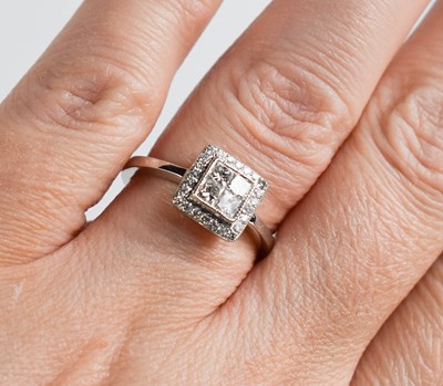 Lot 442 - An 18ct white gold princess cut and brilliant...