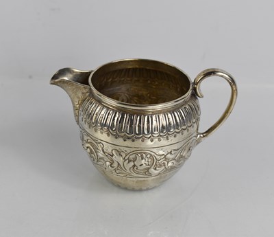 Lot 53 - A silver jug, embossed with scrollwork and...