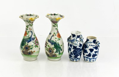 Lot 281 - Two Chinese blue and white bud vases, modelled...