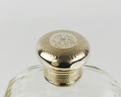 Lot 54 - A silver and glass hip flask, the silver lid...
