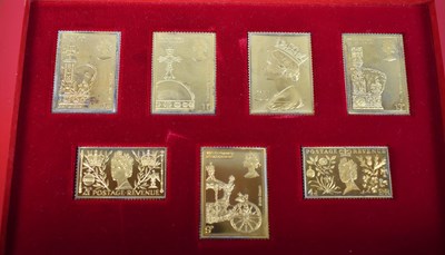 Lot 371 - A boxed set of seven silver gilt stamps, 25th...