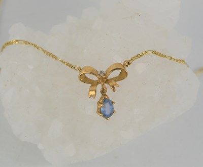 Lot 179 - A 9ct gold necklace with gold ribbon form...