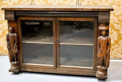 Lot 471 - A 19th century carved oak two door glazed...