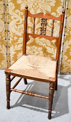 Lot 466 - A Liberty & Co walnut childs chair with rush...