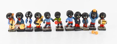 Lot 231 - A group of eleven Robertson Golly figurines.