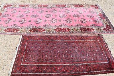 Lot 369 - A large wool carpet with peach ground,...