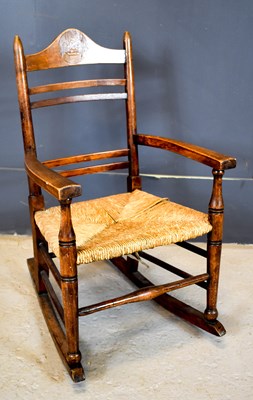 Lot 559 - An Arts and Crafts child's rocking chair, with...