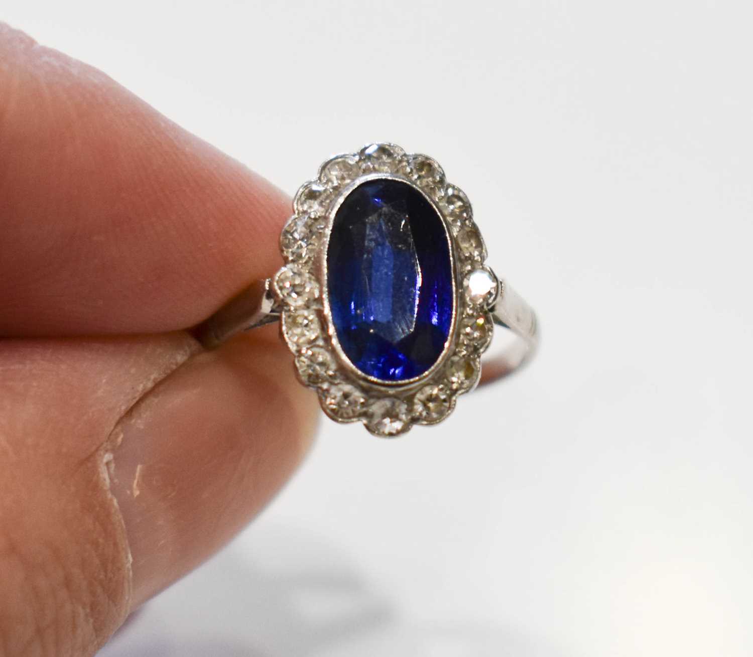 Lot 67 - A sapphire and diamond dress ring, the central...