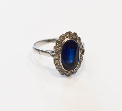 Lot 67 - A sapphire and diamond dress ring, the central...