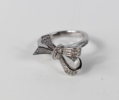 Lot 62 - A silver bow knot pave ring, set with...