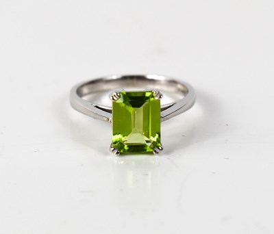 Lot 56 - A 9ct white gold and peridot ring, rectangular...