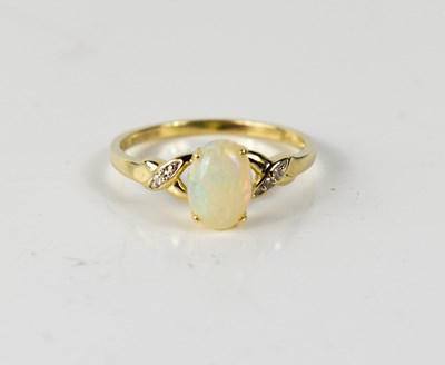 Lot 61 - A 9ct gold oval opal and diamond ring, the...
