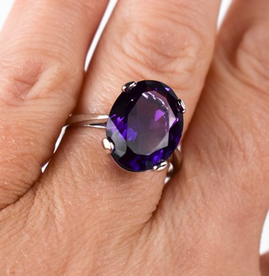 Lot 62 - A 9ct white gold and oval amethyst ring, the...