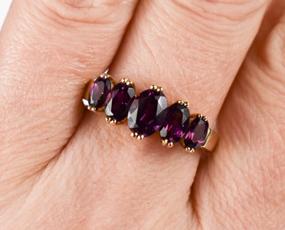 Lot 45 - A 9ct gold and amethyst ring, with five...