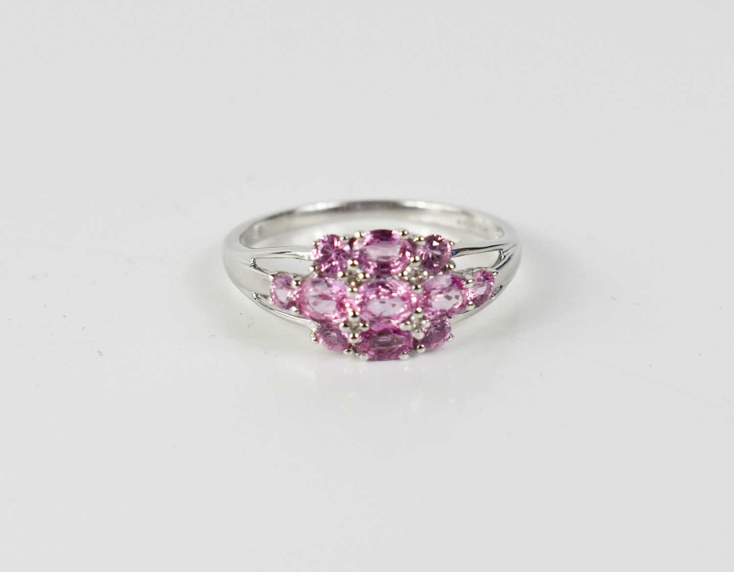 Lot 38 - A 9ct white gold, pink sapphire and diamond...