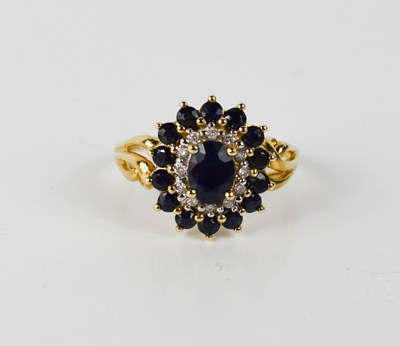 Lot 48 - A 9ct gold, diamond and sapphire cluster ring,...