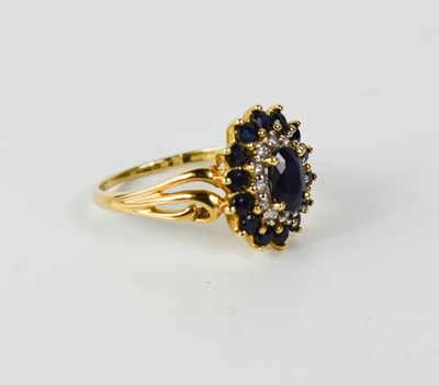 Lot 48 - A 9ct gold, diamond and sapphire cluster ring,...