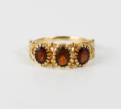 Lot 12 - A 9ct gold vintage garnet three stone ring,...