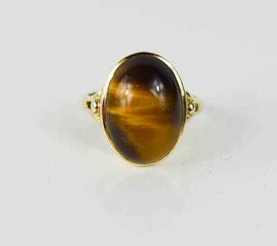 Lot 43 - A 9ct gold and tigers eye oval cabochon ring,...