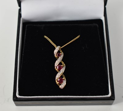 Lot 140 - A 9ct gold, ruby and diamond pendant with a...