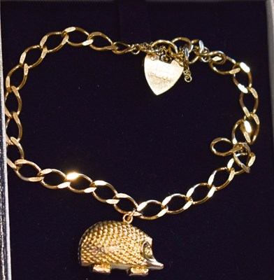 Lot 114 - A 9ct gold charm bracelet with a hedgehog...