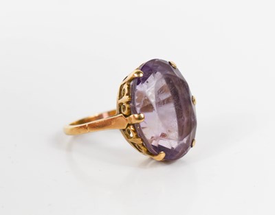Lot 7 - A 9ct gold and amethyst dress ring, the oval...