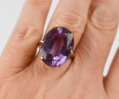 Lot 7 - A 9ct gold and amethyst dress ring, the oval...
