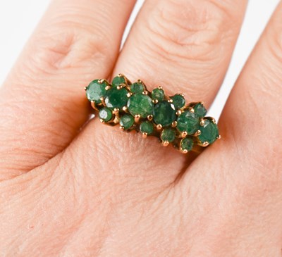 Lot 22 - A 9ct gold and emerald dress ring, set with...