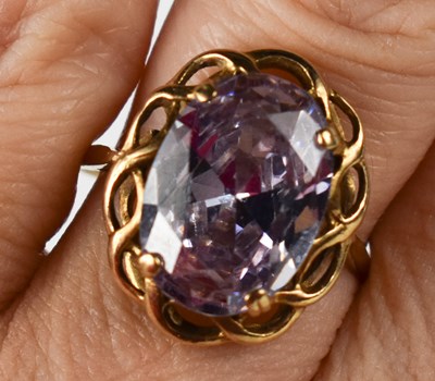 Lot 11 - A 9ct gold and amethyst dress ring, the oval...