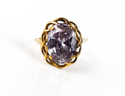 Lot 11 - A 9ct gold and amethyst dress ring, the oval...