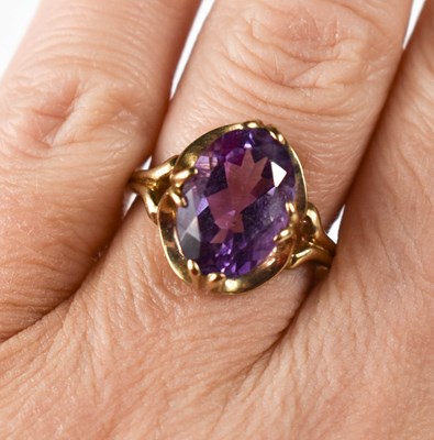 Lot 16 - A 9ct gold and amethyst dress ring, the oval...
