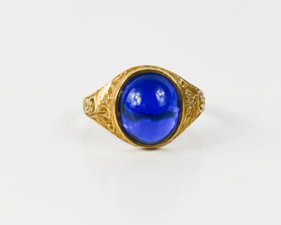 Lot 92 - A 9ct gold and blue stone ring, the cabouchon...