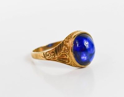 Lot 92 - A 9ct gold and blue stone ring, the cabouchon...