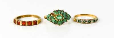 Lot 28 - An Indian 10ct gold and emerald dress ring set...