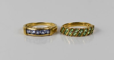 Lot 99 - A 9ct gold and peridot sixteen stone ring, set...