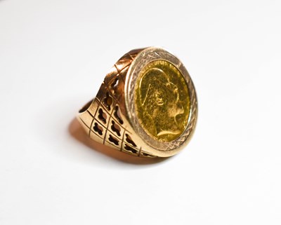 Lot 112 - A gold half sovereign ring, set in 9ct gold,...