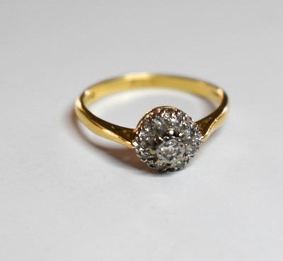 Lot 49 - An 18ct gold and diamond cluster ring, London...