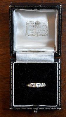 Lot 157 - An 18ct gold and diamond five stone ring, with...