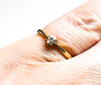 Lot 25 - An 18ct gold, and diamond solitaire ring, set...