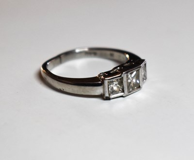 Lot 71 - A platinum and diamond three stone ring, the...