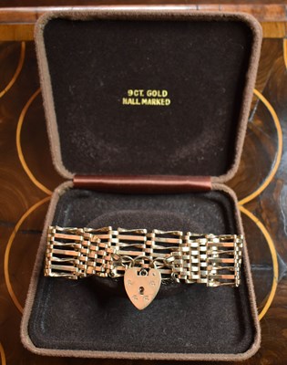 Lot 144 - A 9ct gold seven bar gate bracelet, with the...