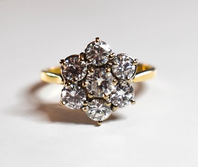 Lot 76 - An 18ct gold and diamond cluster ring, the...