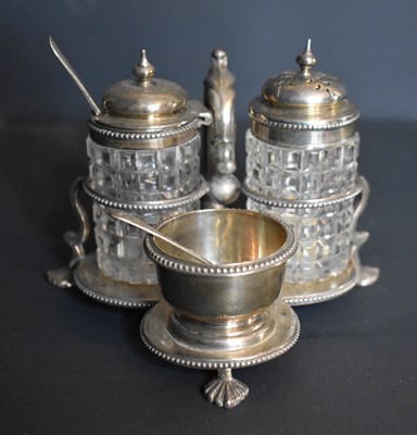 Lot 286 - A Victorian three bottle cruet set with cut...