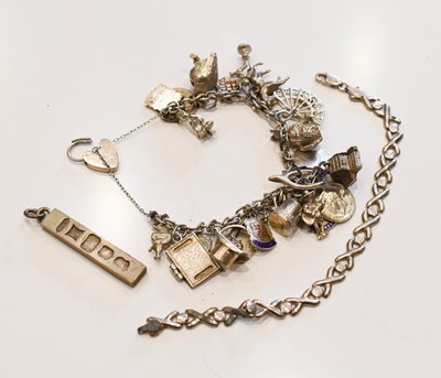 Lot 212 - A silver charm bracelet set with twenty six...