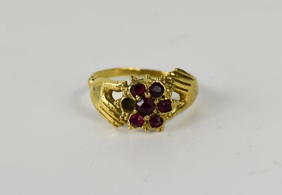 Lot 102 - An 18ct gold and garnet dress ring, of...