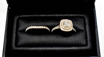 Lot 1a - A platinum and diamond double halo ring, the...