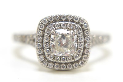 Lot 75 - A platinum and diamond double halo ring, the...