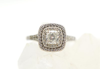 Lot 75 - A platinum and diamond double halo ring, the...
